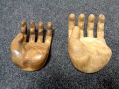 Two hand carved hardwood hands, palms up,