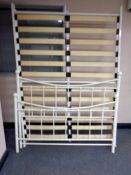 A white painted metal 4ft 6' bed frame