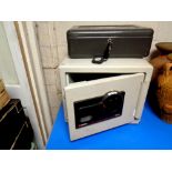 A metal cash box with key together with a further sentry combination fire safe