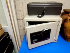 A metal cash box with key together with a further sentry combination fire safe