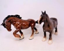 A Royal Doulton cantering shire horse together with a further shire horse by Beswick (2)