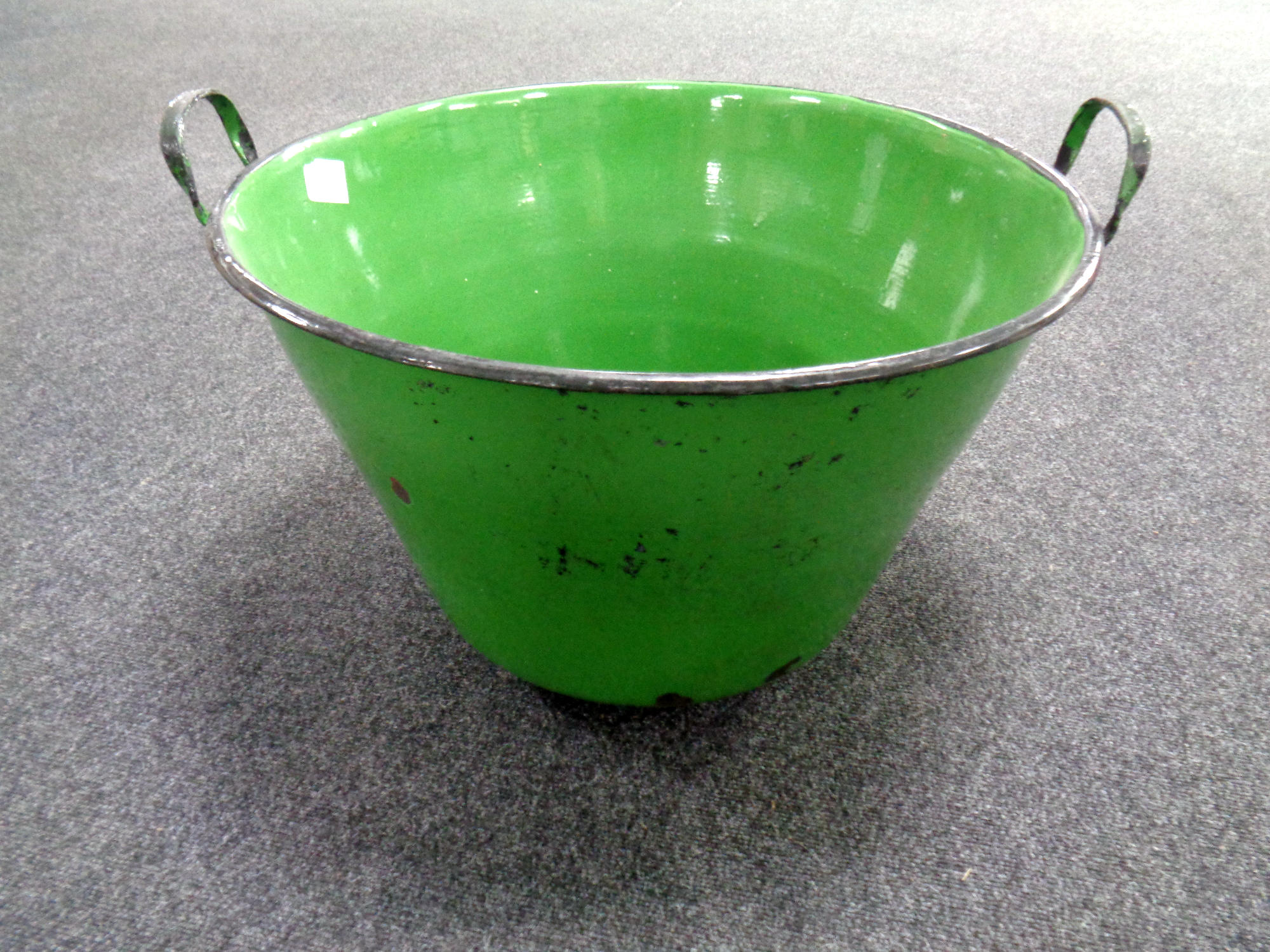 A large green enamel bin