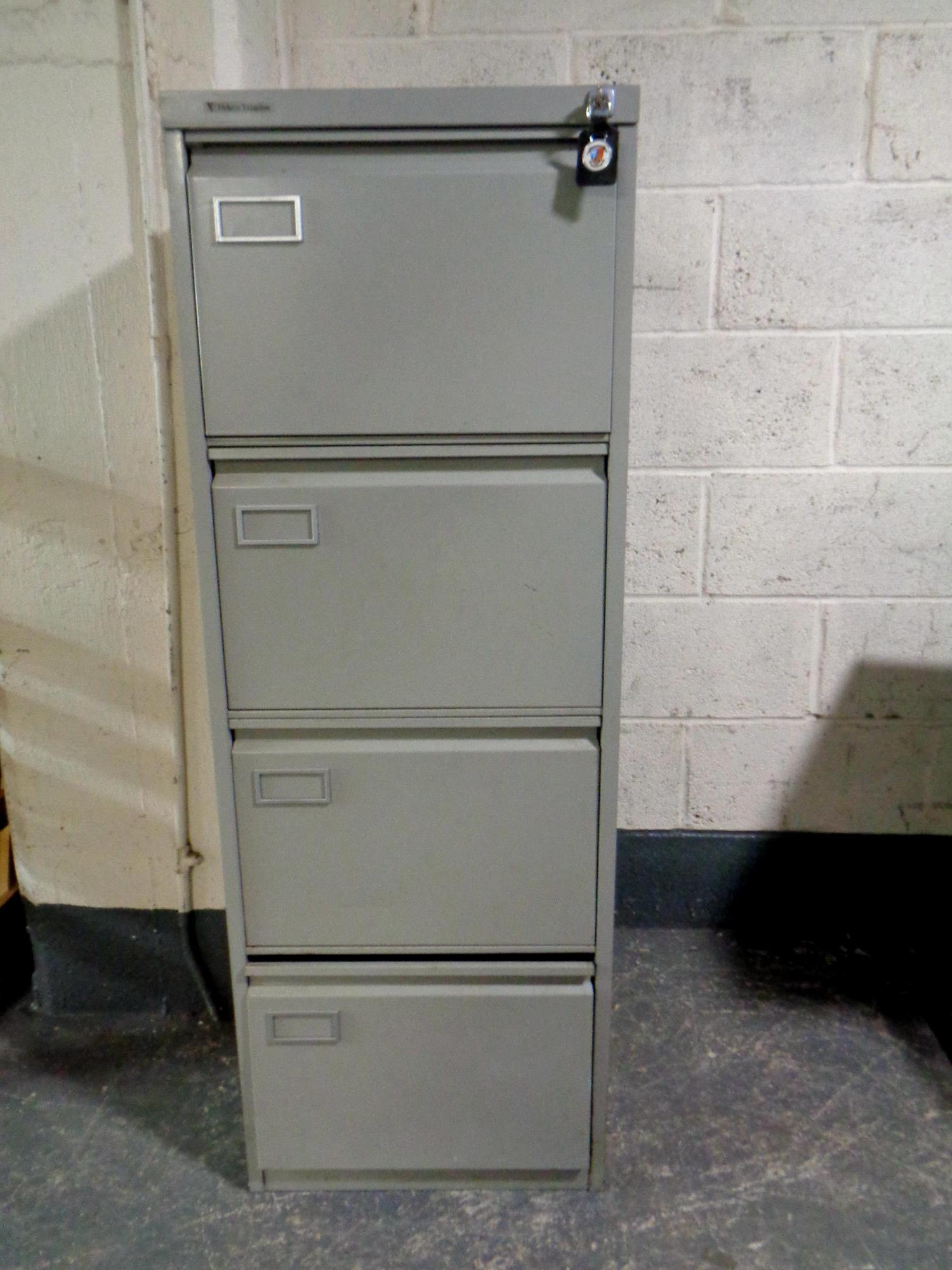 A metal four drawer filing cabinet by Vickers with key