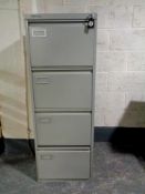 A metal four drawer filing cabinet by Vickers with key