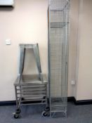 A stainless steel trolley together with a metal stool and a cage locker