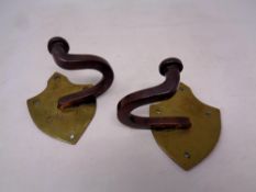 A pair of antique brass mounted coat hooks