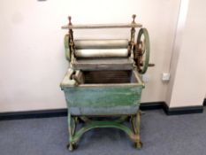 An antique cast metal and wooden mangle/wash station,