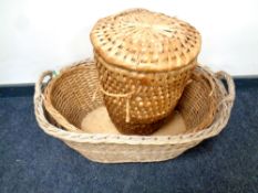 Two 20th century oval wicker baskets together with a laundry bin