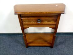A contemporary oak hall table fitted a drawer,