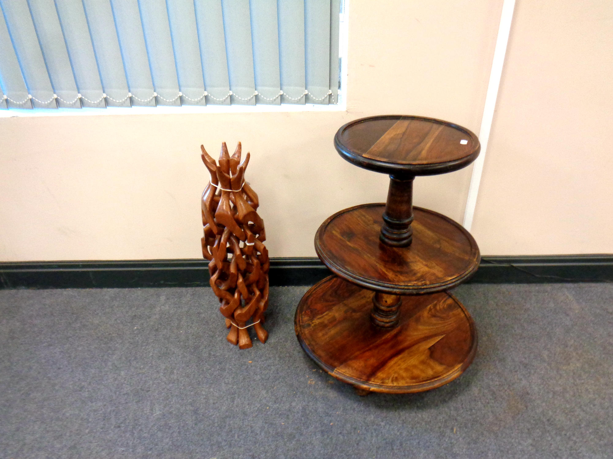A three tier hardwood occasional table together with an African wooden table stand