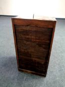 An early 20th century sliding door shutter cabinet with key