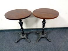 A pair of cast iron based circular pub tables,