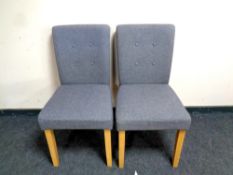 A pair of contemporary grey upholstered dining chairs