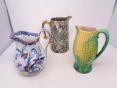 An English Majolica sweet corn jug together with two Victorian jugs