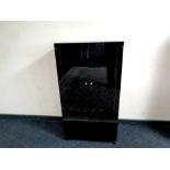 A high gloss fold out double door storage cabinet,