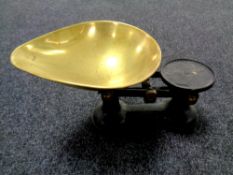 An antique set of kitchen scales with brass pan