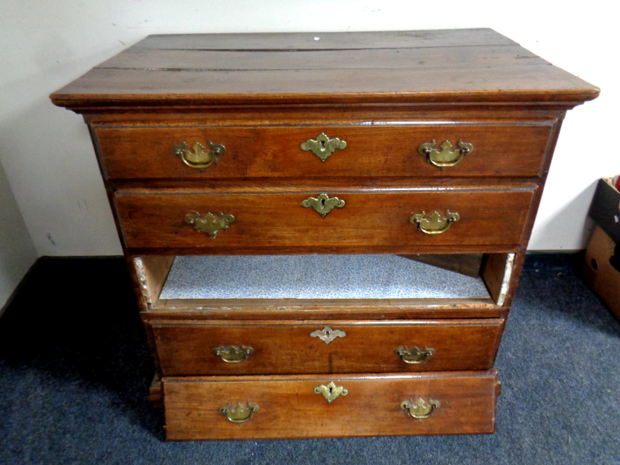 A Georgian oak four drawer chest with brass handles on bracket feet,