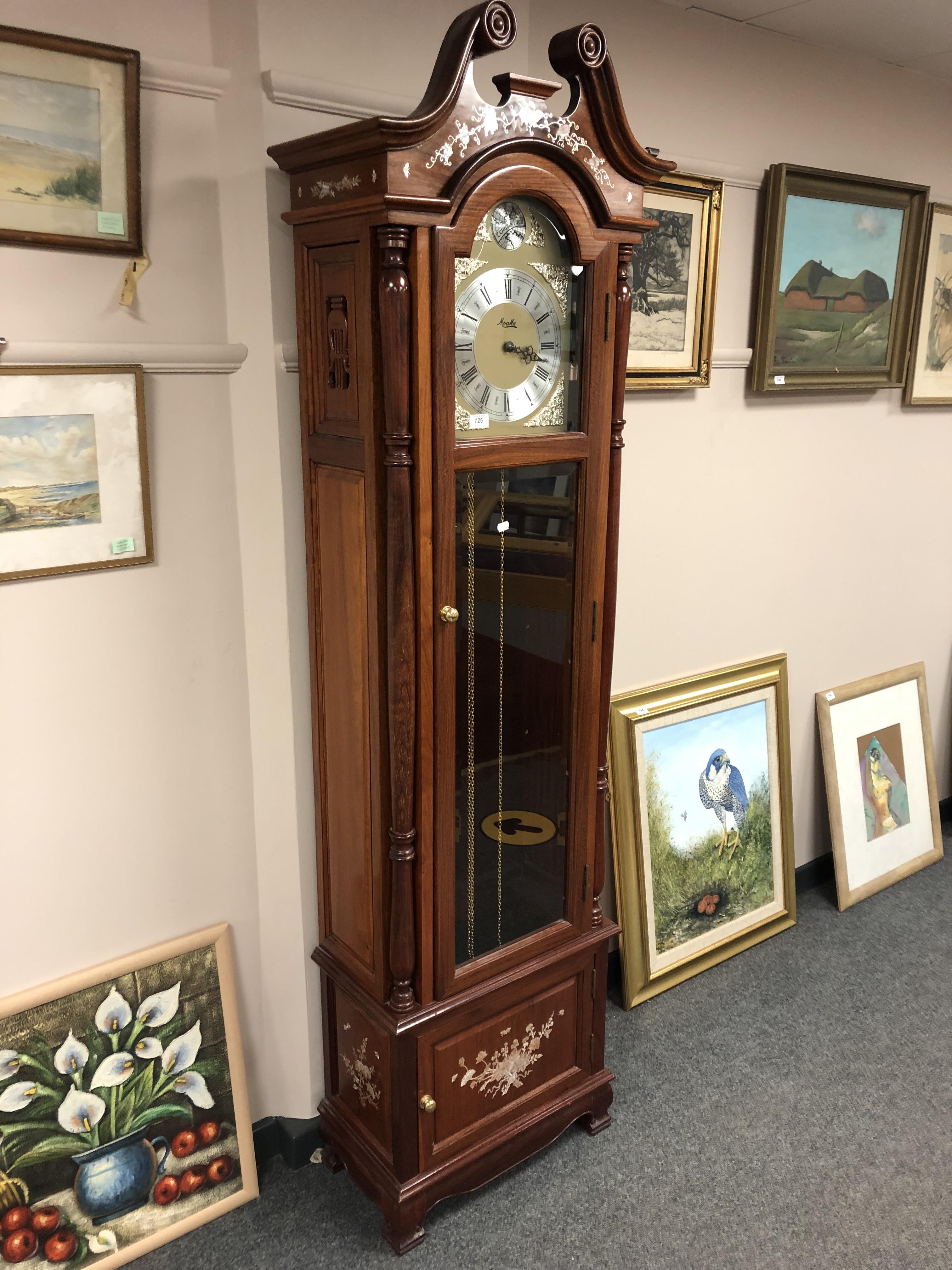 A contemporary hardwood regulator clock with mother of pearl inlay, two weights and a pendulum,