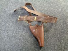 An early 20th century leather 'Sam Brown' pistol holster on belt