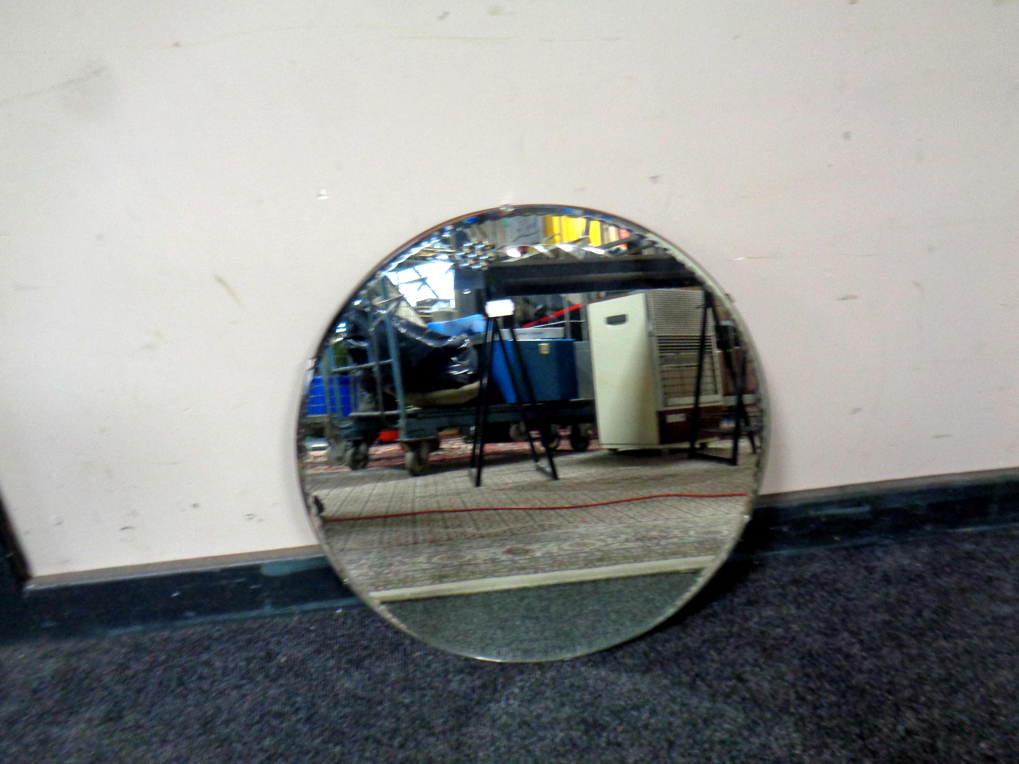 An early 20th century circular frameless mirror