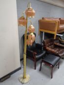 A brass five way floor lamp with glass shades (continental wiring)