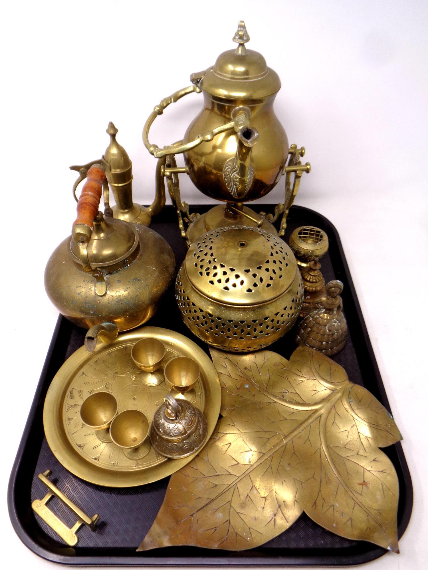 A tray containing assorted brass wares to include eastern teapot, spirit kettle on stand,