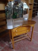 A mid 20th century kidney shaped dressing table with triple mirror