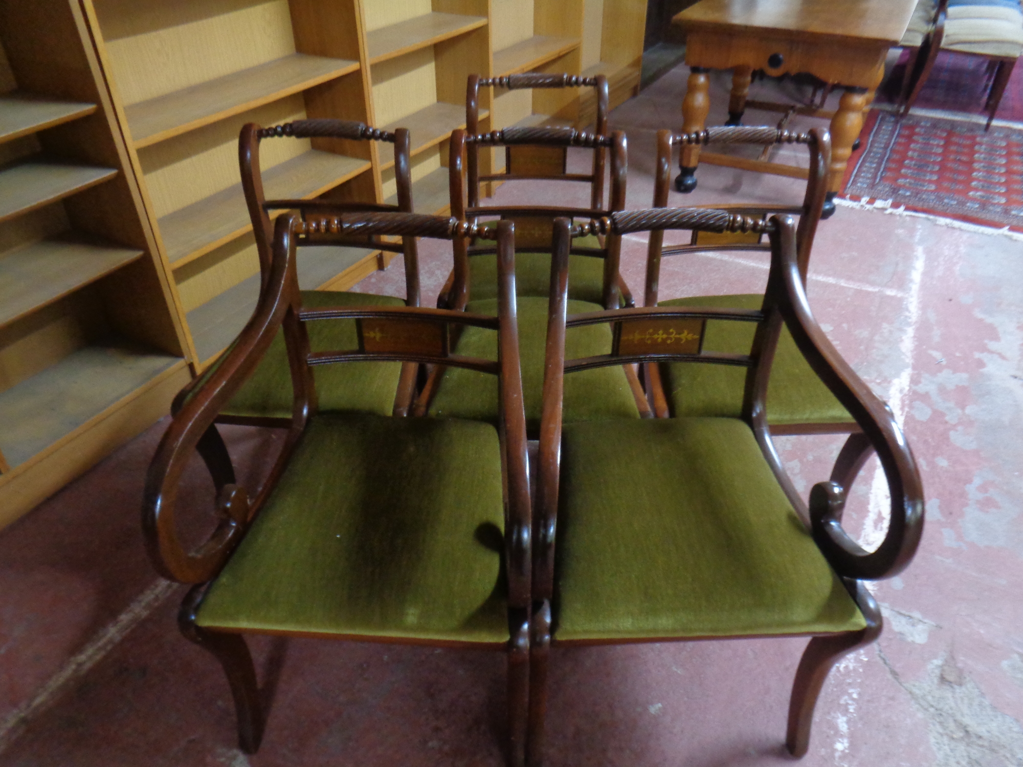 A set of six mahogany brass inlaid regency style dining chairs comprising of two carvers and four