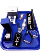 A tray containing assorted lady's and gent's wristwatches to include Storm, Swarovski,