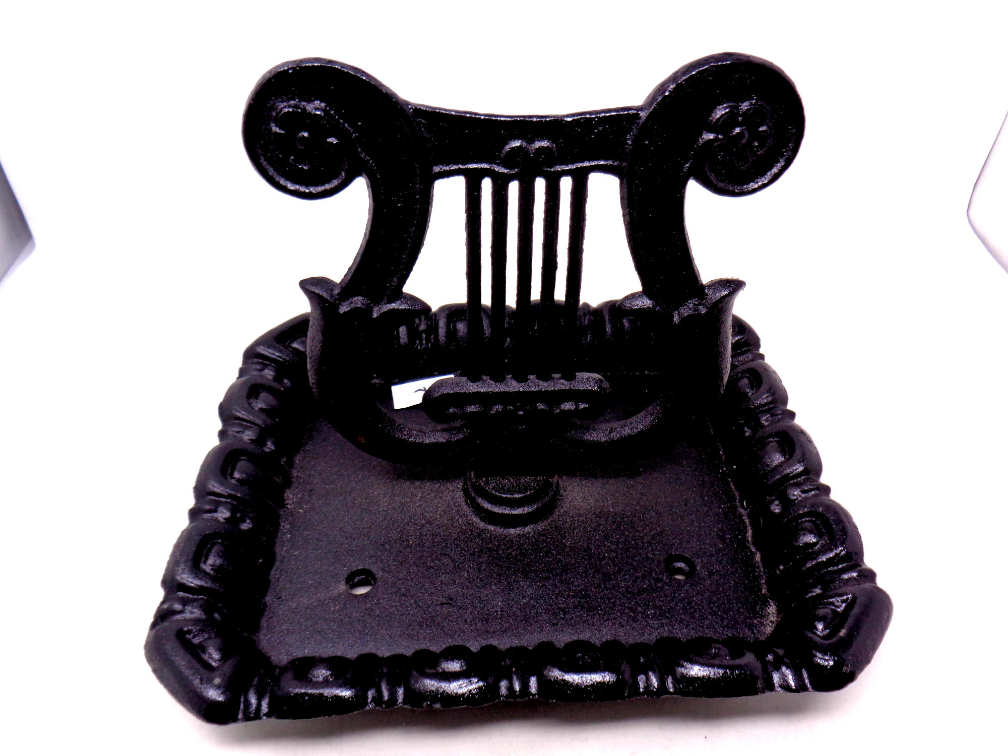 A cast iron Lyre boot scraper