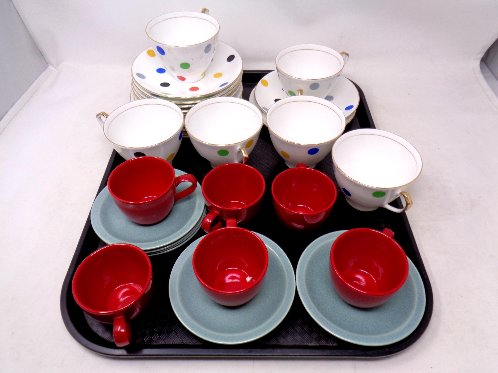 A tray containing six Imperial bone china polka dot trios together with six Vogue coffee cups with