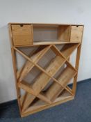 A pine wine rack fitted two drawers