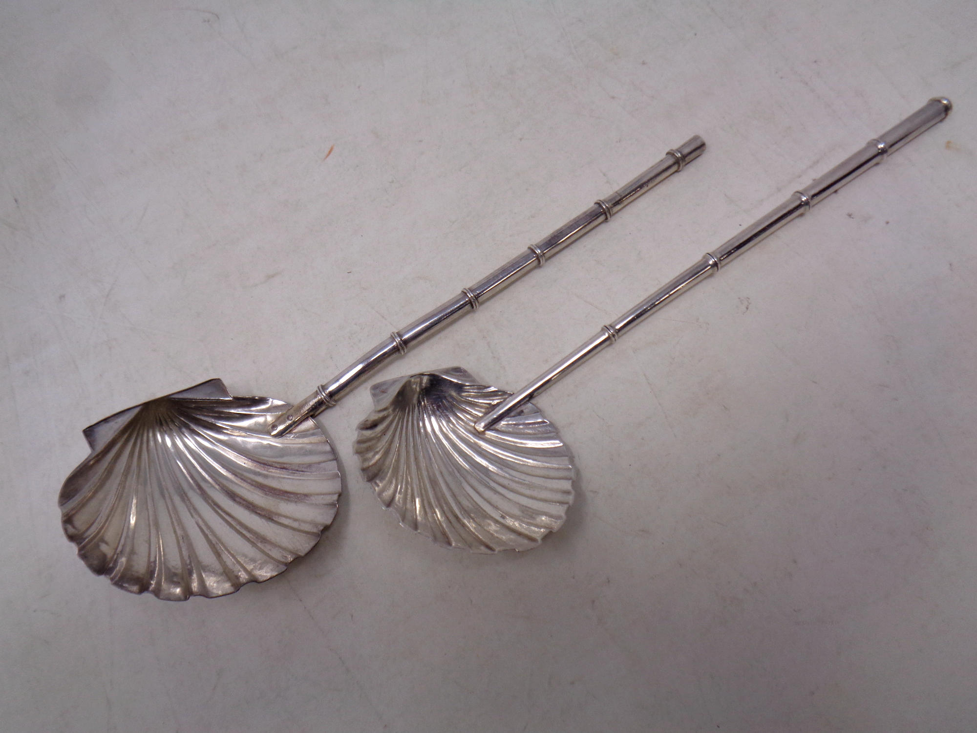 Two silver shell serving spoons