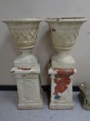 A pair of concrete urns on chimney pots