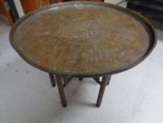 A folding eastern brass topped table