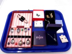 A tray containing cased silver plated Art Deco teaspoons with sugar tongs, costume jewellery,