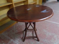 A circular occasional table on bentwood base