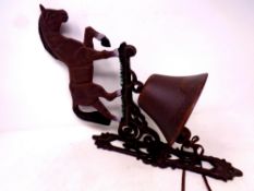 A cast iron horse wall bracket with bell