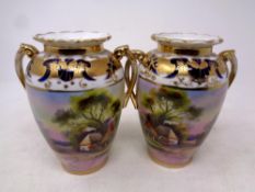 A pair of Noritake twin handled gilded vases, height 15.