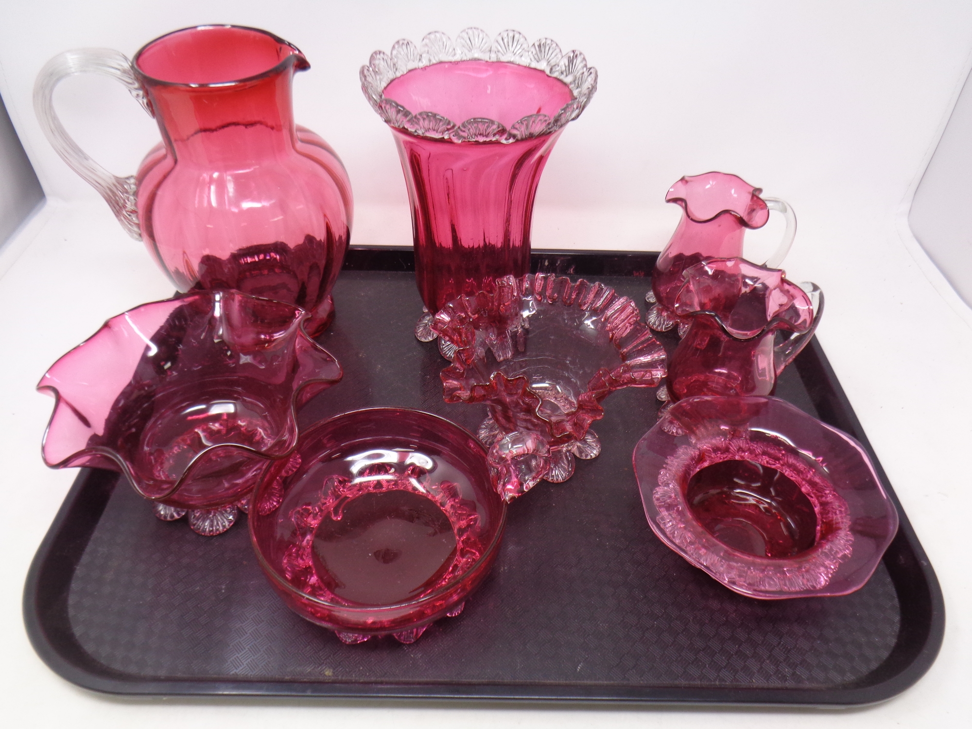 A tray containing eight pieces of antique cranberry glassware