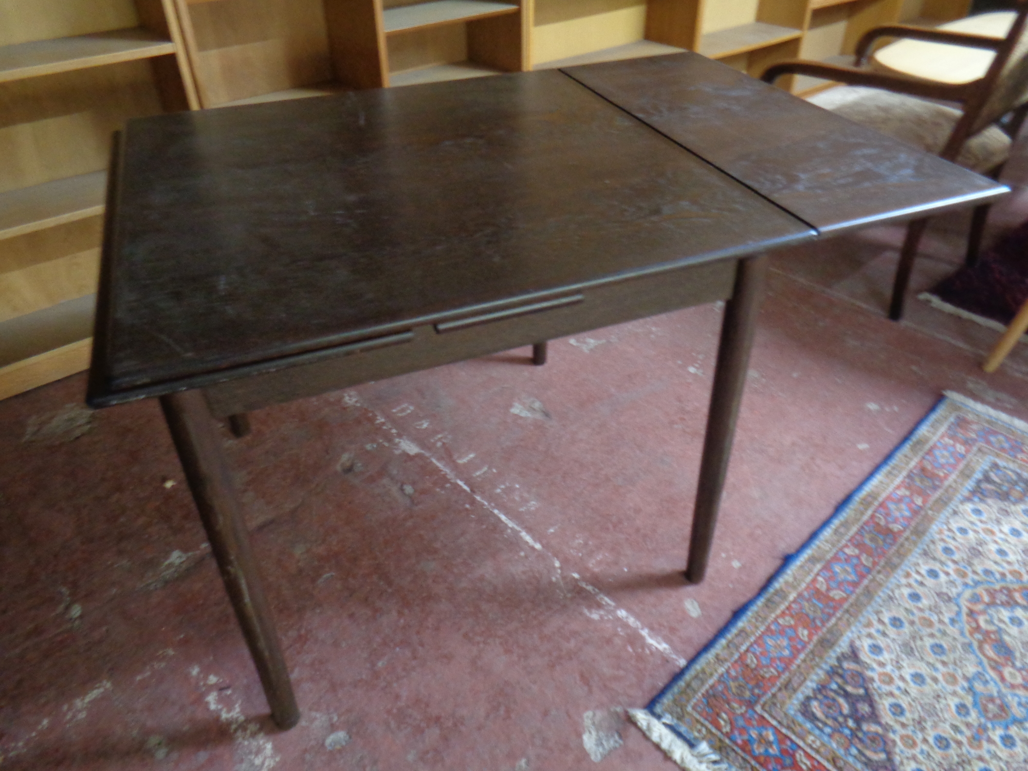 A mid 20th century square pull out dining table