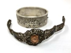 A silver cuff bangle with floral decoration, 32.