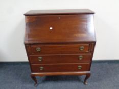 An early 20th century mahogany fall front writing bureau fitted three drawers on Queen Anne legs