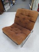 A 20th century Scandinavian tubular metal chair with a brown corded cushion