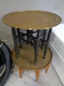 Two eastern brass topped tables