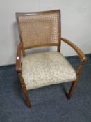 A 20th century beech bergere backed armchair