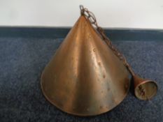 A copper conical pendant light fitting