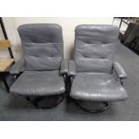 A pair of 20th century tubular metal swivel armchairs upholstered in a grey leather