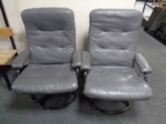 A pair of 20th century tubular metal swivel armchairs upholstered in a grey leather