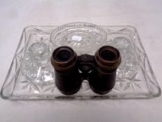A four piece cut glass trinket set together with a pair of vintage field glasses
